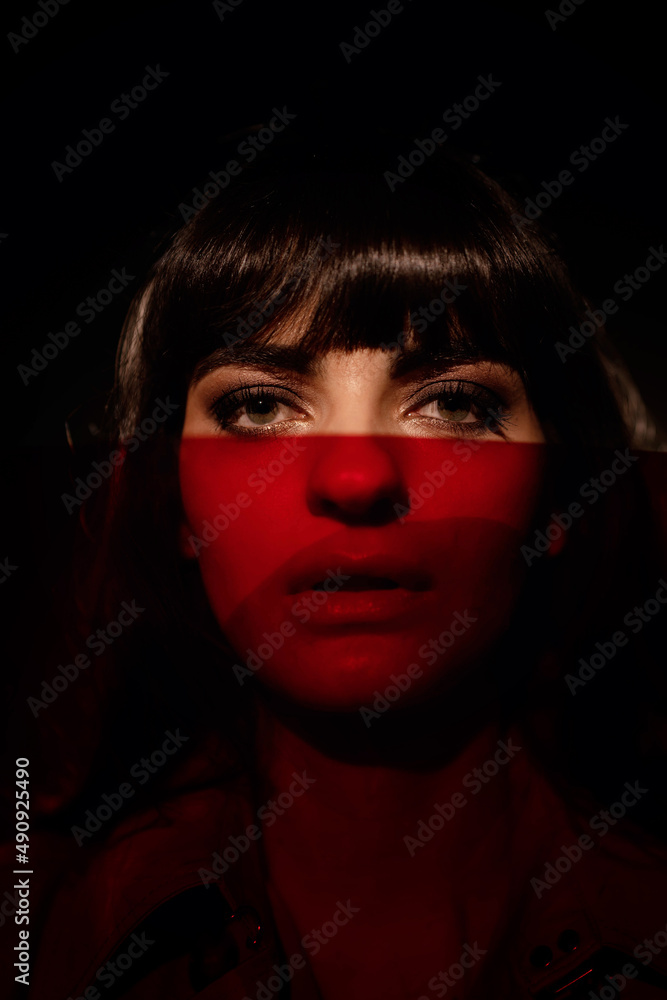 portrait of a girl in the studio with color filters in a dark key portrait of a girl in the studio with color filters in a dark key