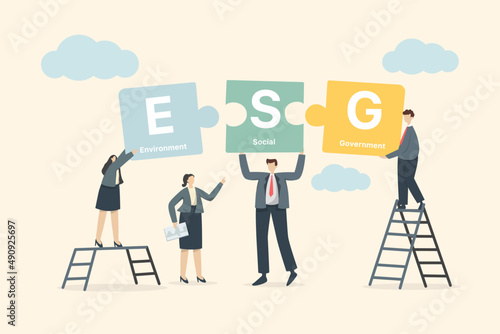The ESG concept businessmen try to combine on a jigsaw. Environmental, Social and Governance in Sustainable and Ethical Business on Network Green Background
