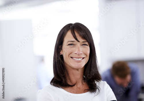 She always delivers top-quality work. Portrait of an attractive businesswoman standing in an office environment.