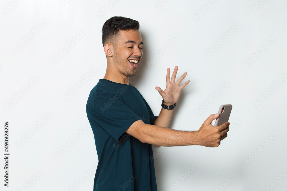 happy young man using mobile phone isolated on white background
happy young man using mobile phone isolated on white background