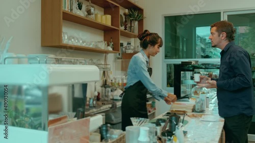 Angry customer complaining about barista in coffee shop photo