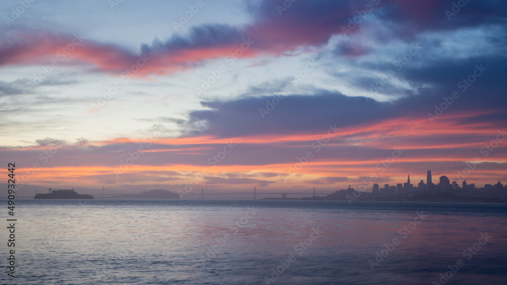 A sunrise on the Bay with the City by the Bay and Alcatraz in silhouette 