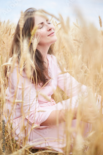 happy and peaceful Ukrainian woman in wheat field. Mariupol, Ukraine