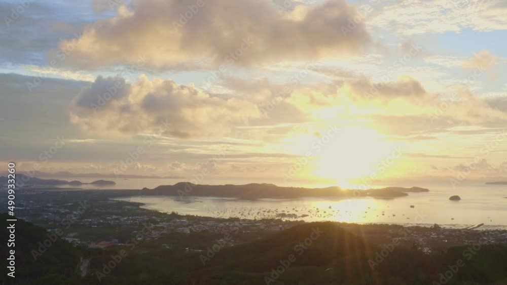 aerial view bright sunrise above Chalong sea Phuket..beautiful cloud over archipelago..lens flare background. 4k stock footage video. aerial view bright sunrise above Chalong sea Phuket..beautiful cloud over archipelago..lens flare background. 4k stock footage video.