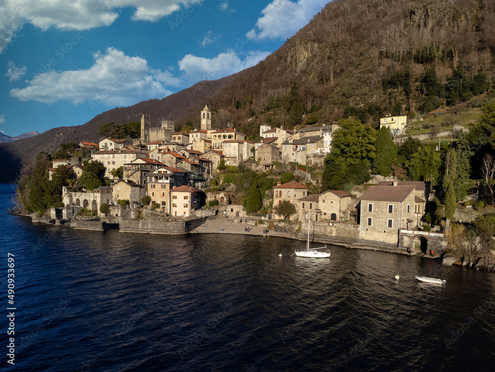 AERIAL VIEW. Scenic picture, postcard view from the lake of a little old village in Lombardy, Lake Como region, Italy