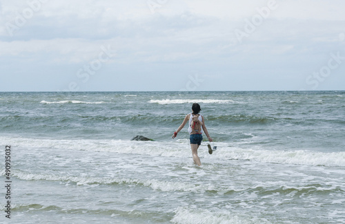 A Girl Walking Through the Sea