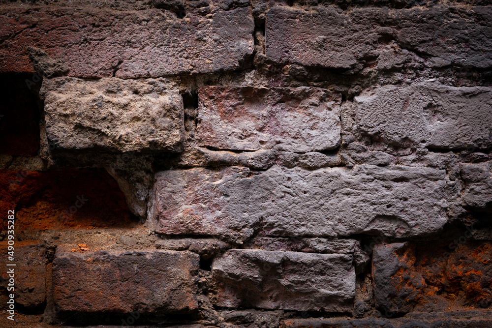 Fototapeta premium Old, black brick wall torn