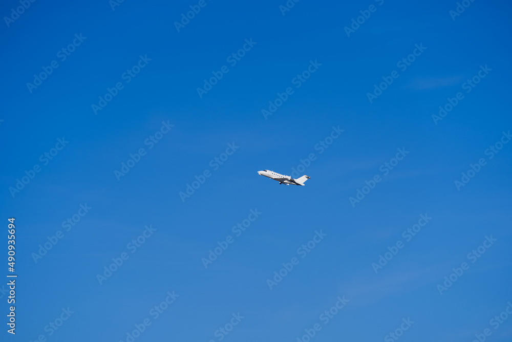 White private jet taking off from Zürich Airport on a sunny winter day. Photo taken February 13th, 2022, Zurich, Switzerland. White private jet taking off from Zürich Airport on a sunny winter day. Photo taken February 13th, 2022, Zurich, Switzerland.