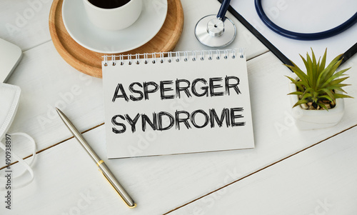Doctor keeps a card with the name of the diagnosis -asperger syndrome. Selective focus. photo