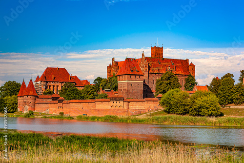 Poland. Malbork. The Castle of the Teutonic Order (UNESCO World Heritage Site) seen from the Nogat river photo