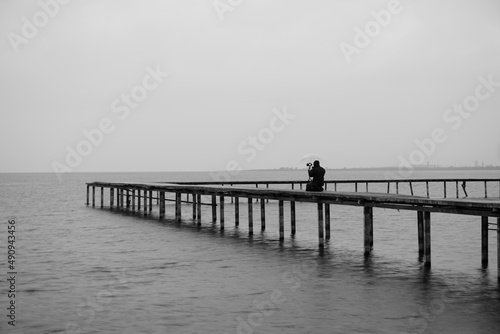 Shot of man taking pictures on the pier © fatihyvg
