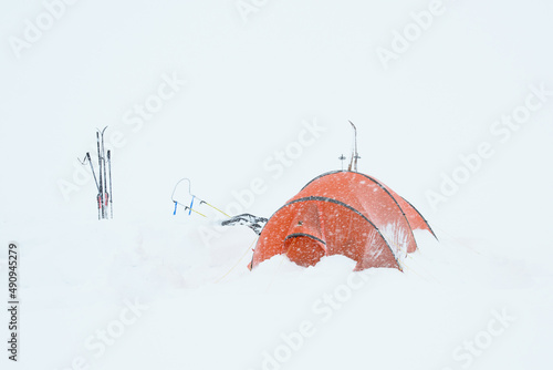 orange tent in blizzard
