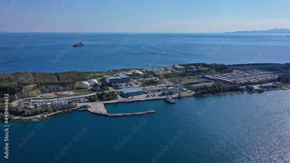 Aerial drone bird's eye view photo from island of Psitaleia the largest sewage treatment plant in Europe, Saronic gulf, Peiraeus, Attica, Greece