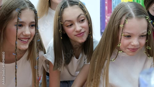 A group of teenage girls look at the monitor and laugh emotionally. Use of social networks