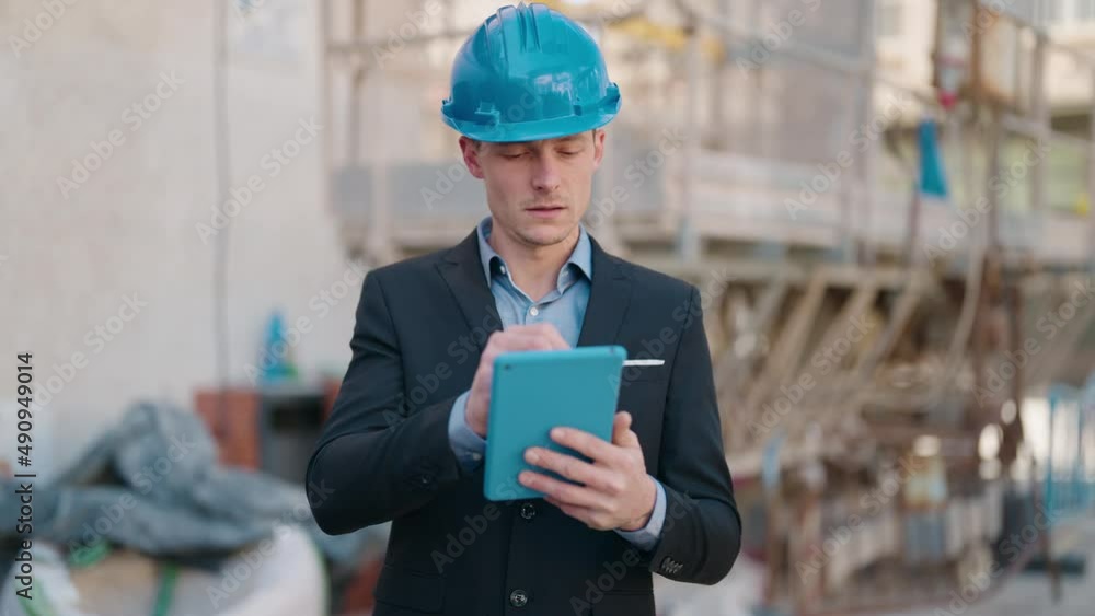 Young caucasian man architect with relaxed expression using touchpad at street Young caucasian man architect with relaxed expression using touchpad at street
