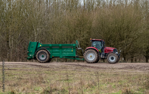 Case Puma 340 red tractor towing a Samson Flex-16 green muck spreader