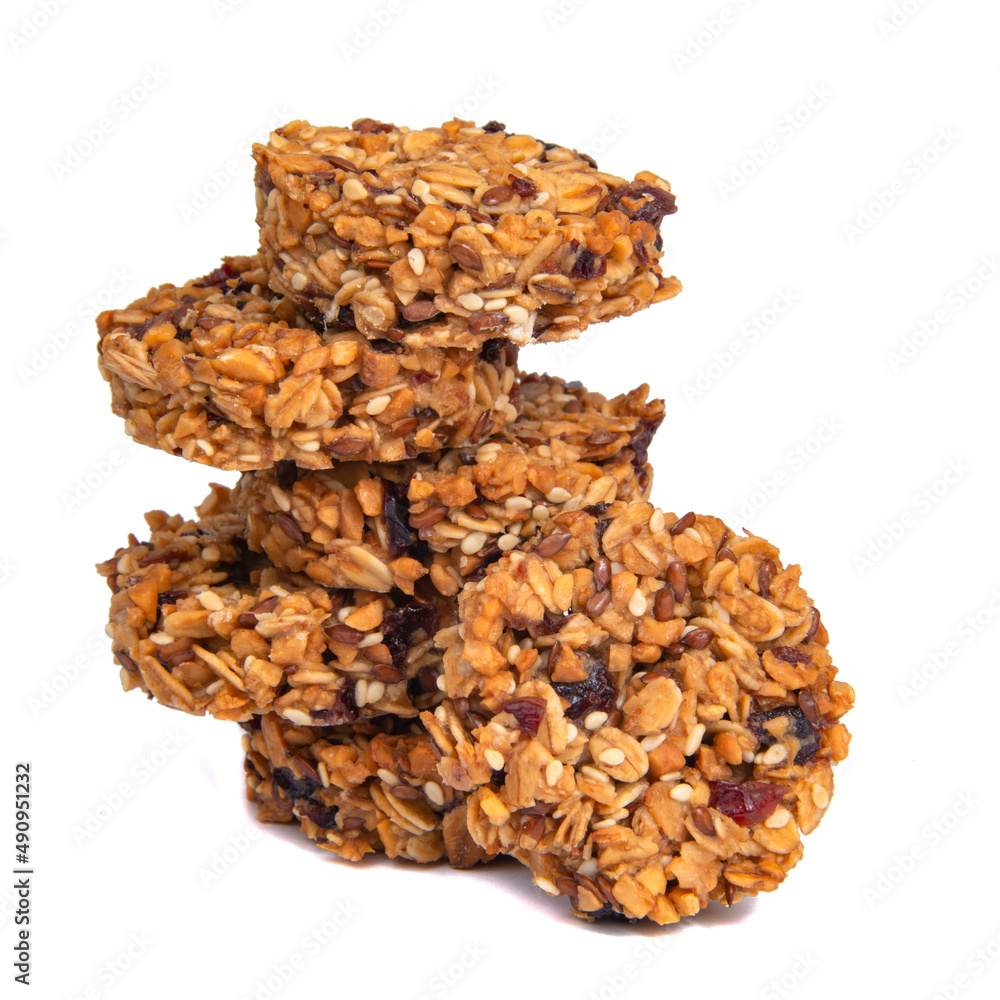 Tower of cookies with honey oatmeal grain isolated on the white Tower of cookies with honey oatmeal grain isolated on the white