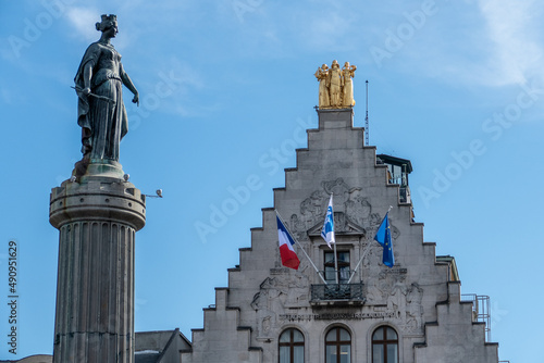 Lille, France, February 28, 2022. Column of Victory, Column of the Goddess with the flags of the La Voix du Nord facade