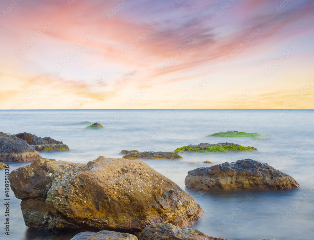 quiet stony sea coast at the dramatic sunset, summer sea scene