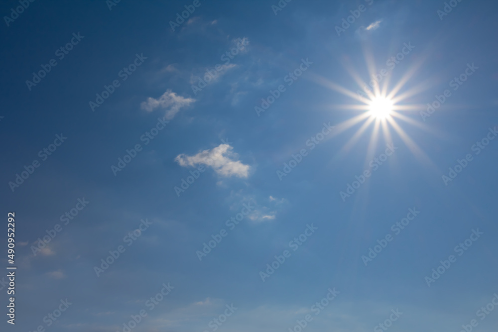 bright blue cloudy sky with sparkle sun, natural sky background