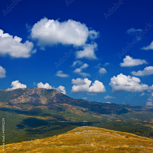 green mountain valley under cloudy sky, outdoor travel scene