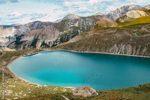 High altitude lake at the foot of the mountains and mountain ranges in the French Alpes