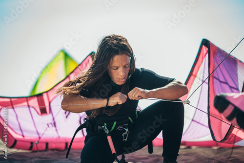 Woman using flying lines and a control bar for kitesurfing photo