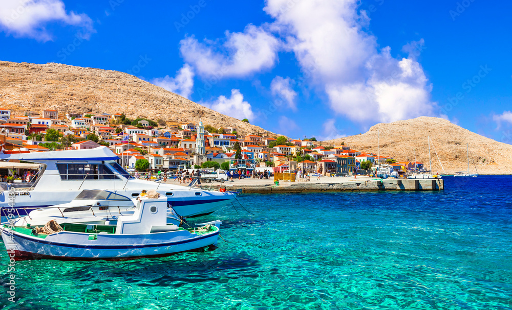 Fototapeta premium Traditional Greece fishing villages - charming Chalki (Halki) island in Dodecanese. view with typical boats and colorful houses