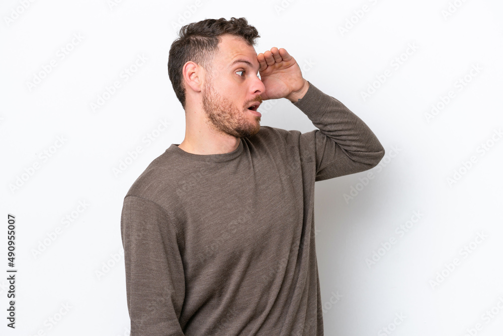 Young Brazilian man isolated on white background with surprise expression while looking side Young Brazilian man isolated on white background with surprise expression while looking side