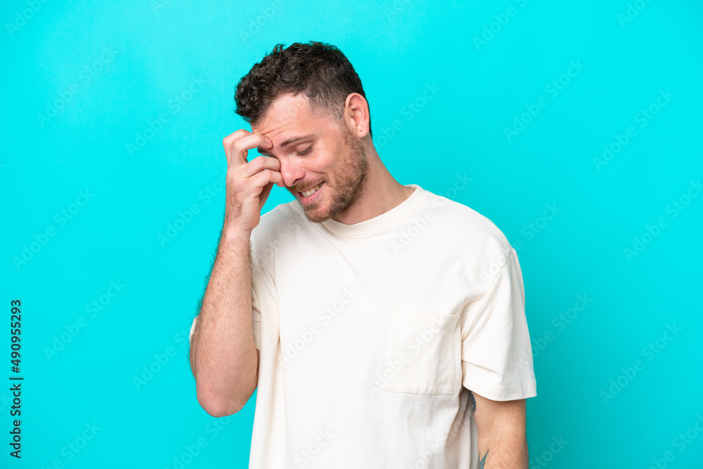 Young Brazilian man isolated on blue background laughing Young Brazilian man isolated on blue background laughing