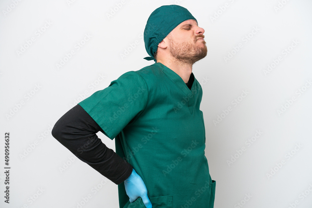 Surgeon Brazilian man in green uniform isolated on white background suffering from backache for having made an effort Surgeon Brazilian man in green uniform isolated on white background suffering from backache for having made an effort