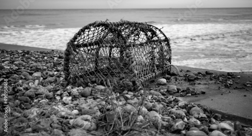 Valokuva Abandoned lobster pot on the beach in black and white