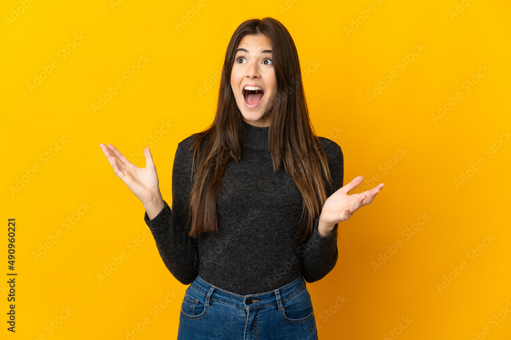 Teenager Brazilian girl isolated on yellow background with surprise facial expression Teenager Brazilian girl isolated on yellow background with surprise facial expression