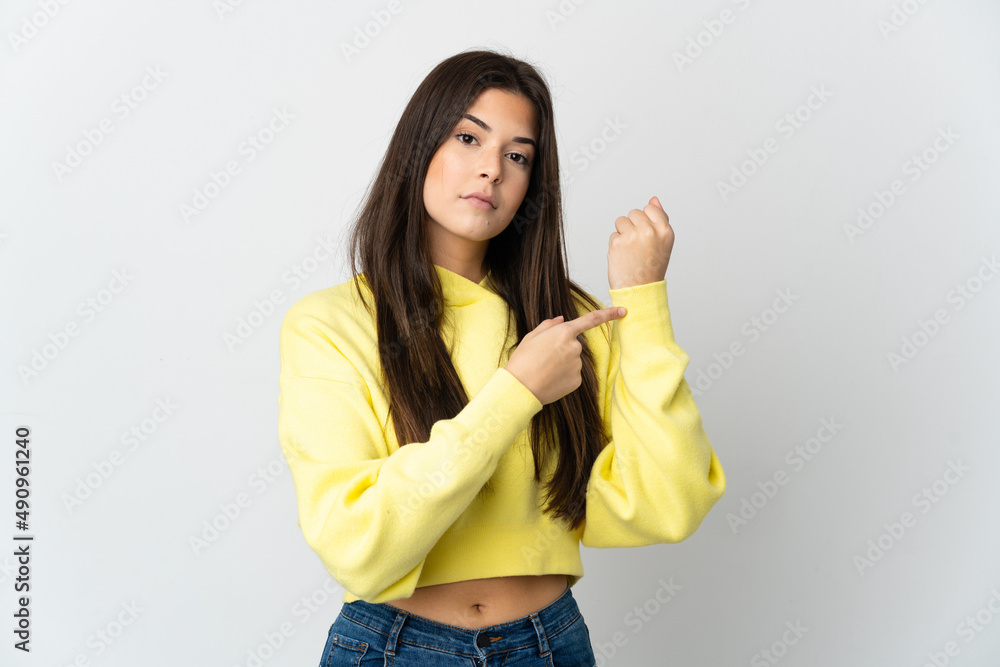 Teenager Brazilian girl isolated on white background making the gesture of being late Teenager Brazilian girl isolated on white background making the gesture of being late
