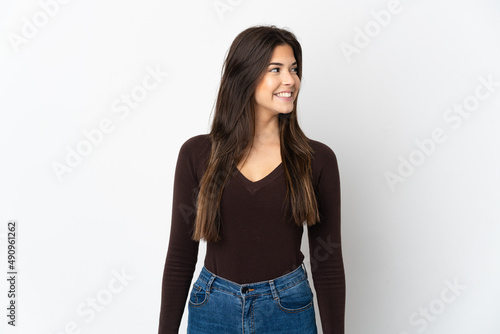 Teenager Brazilian girl isolated on white background looking side © luismolinero