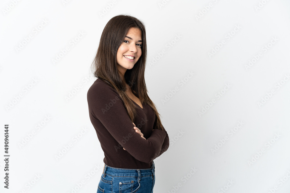 Teenager Brazilian girl isolated on white background with arms crossed and looking forward Teenager Brazilian girl isolated on white background with arms crossed and looking forward