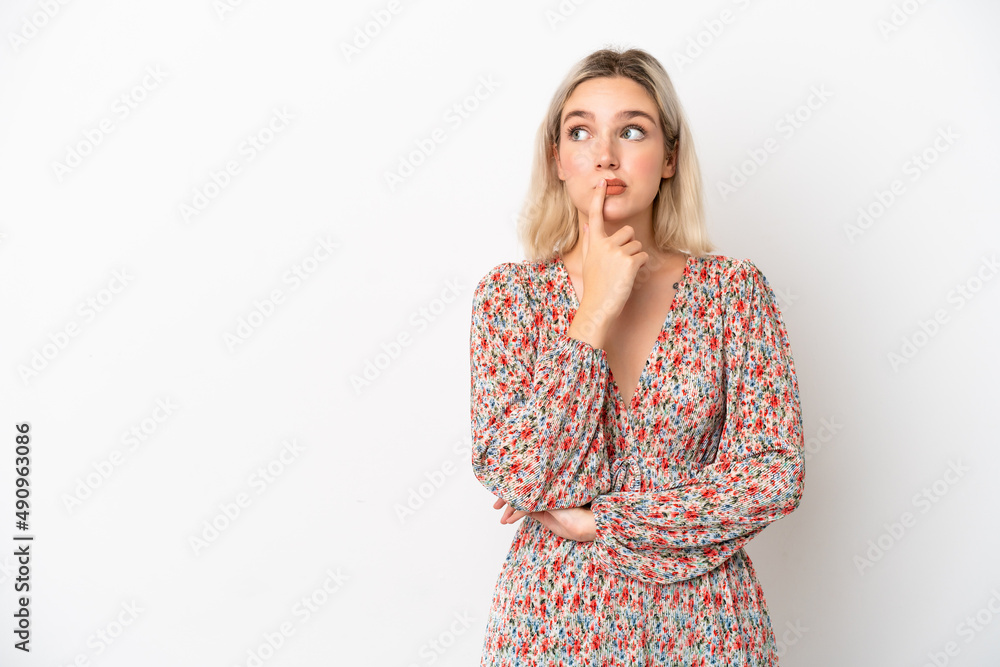Young caucasian woman isolated on white background having doubts while looking up Young caucasian woman isolated on white background having doubts while looking up