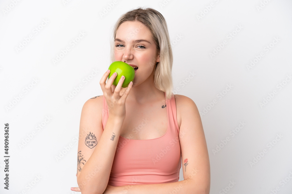 Young caucasian woman isolated on white background eating an apple Young caucasian woman isolated on white background eating an apple