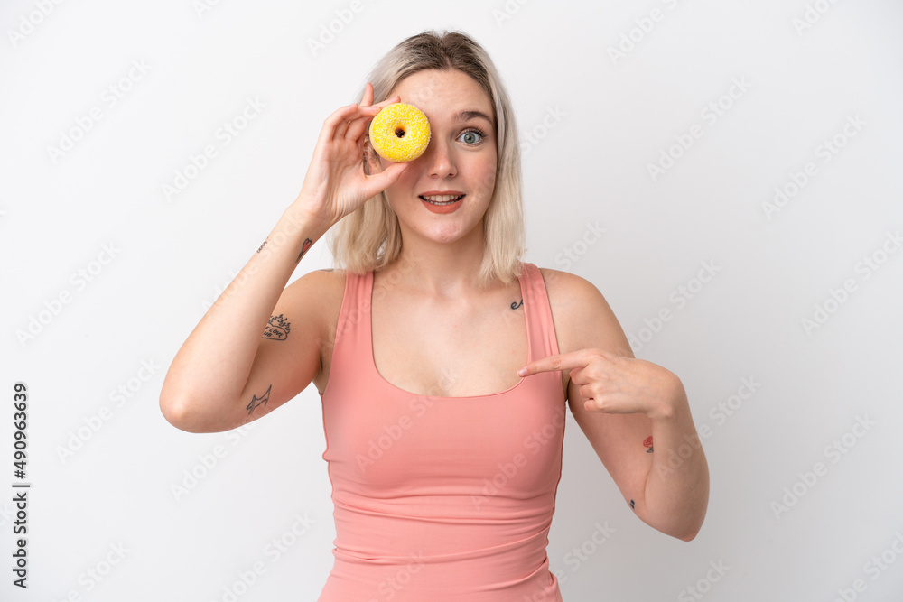 Young caucasian woman isolated on white background holding a donut and happy Young caucasian woman isolated on white background holding a donut and happy