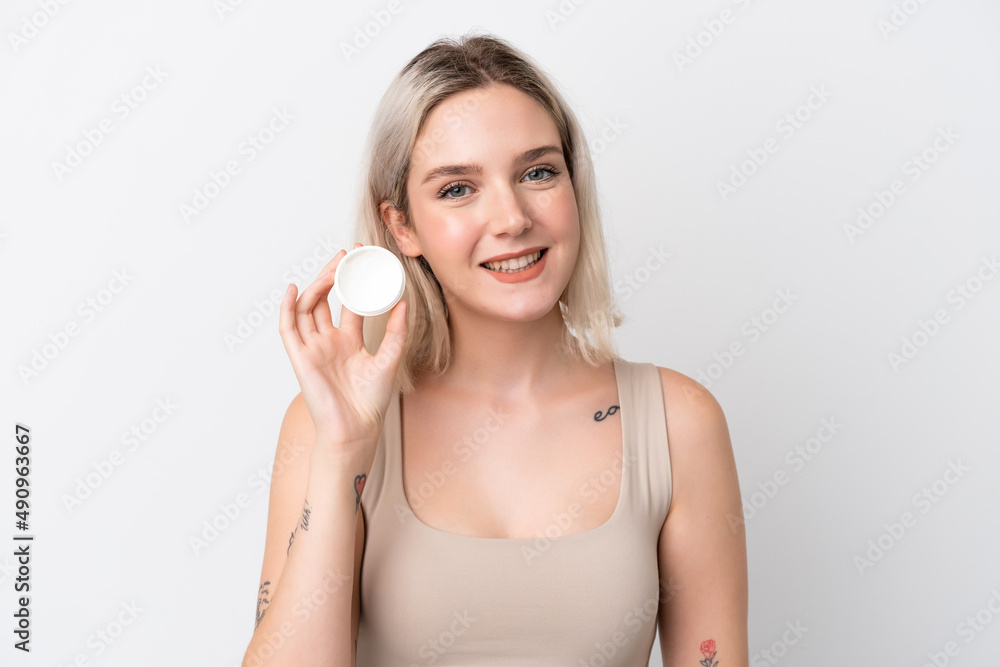 Young caucasian woman isolated on white background with moisturizer and happiness Young caucasian woman isolated on white background with moisturizer and happiness