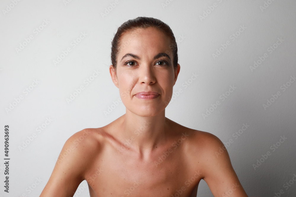 Young caucasian woman looking at the camera over white background. Isolated.