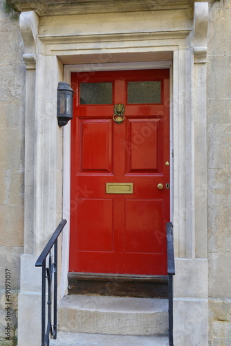 red front door of an old house © 1000 Words