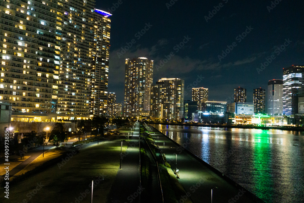 Night view of a high-rise condominium along an urban river_22