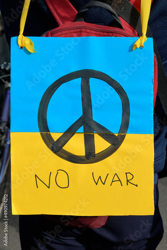 Closeup on packard with with pacific sign on Ukrainian yellow blue flag with English text No War. Protest against war in Ukraine. photo