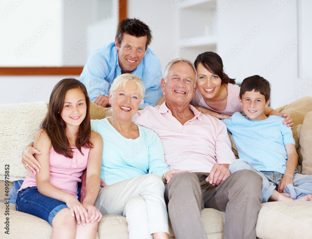 Going through life together - Family Support. Three generations of family sitting together affectionately on the lounge couch. Going through life together - Family Support. Three generations of family sitting together affectionately on the lounge couch.
