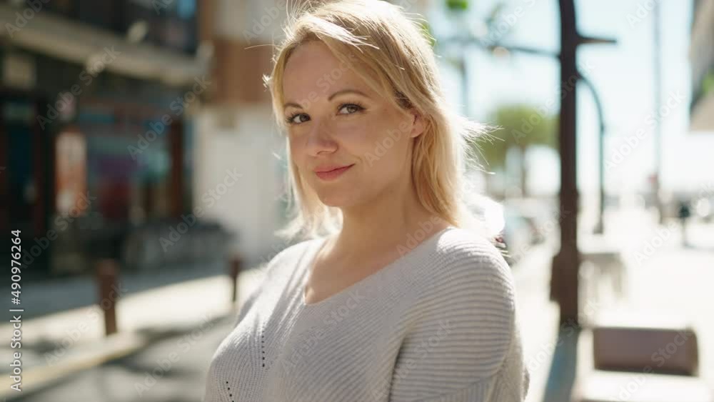 Young blonde woman smiling confident standing at street Young blonde woman smiling confident standing at street