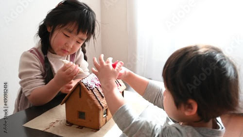 Boys and girls decorate the candy house