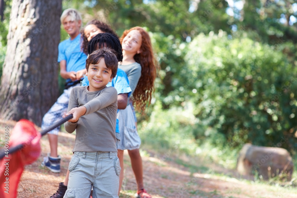 Pull. Children playing at tug-of-war in the woods. Pull. Children playing at tug-of-war in the woods.