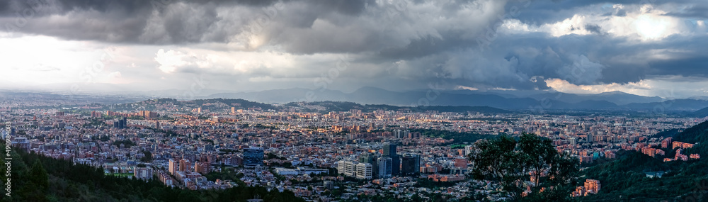 Panorama of the high plateau with the Colombian capital Bogota with dramatic cloudy sky and sunlight