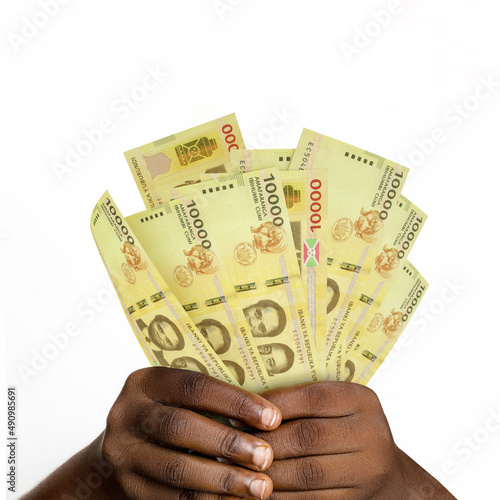 hands holding 3D rendered 10000 Burundian franc notes. closeup of Hands holding Burundian currency notes